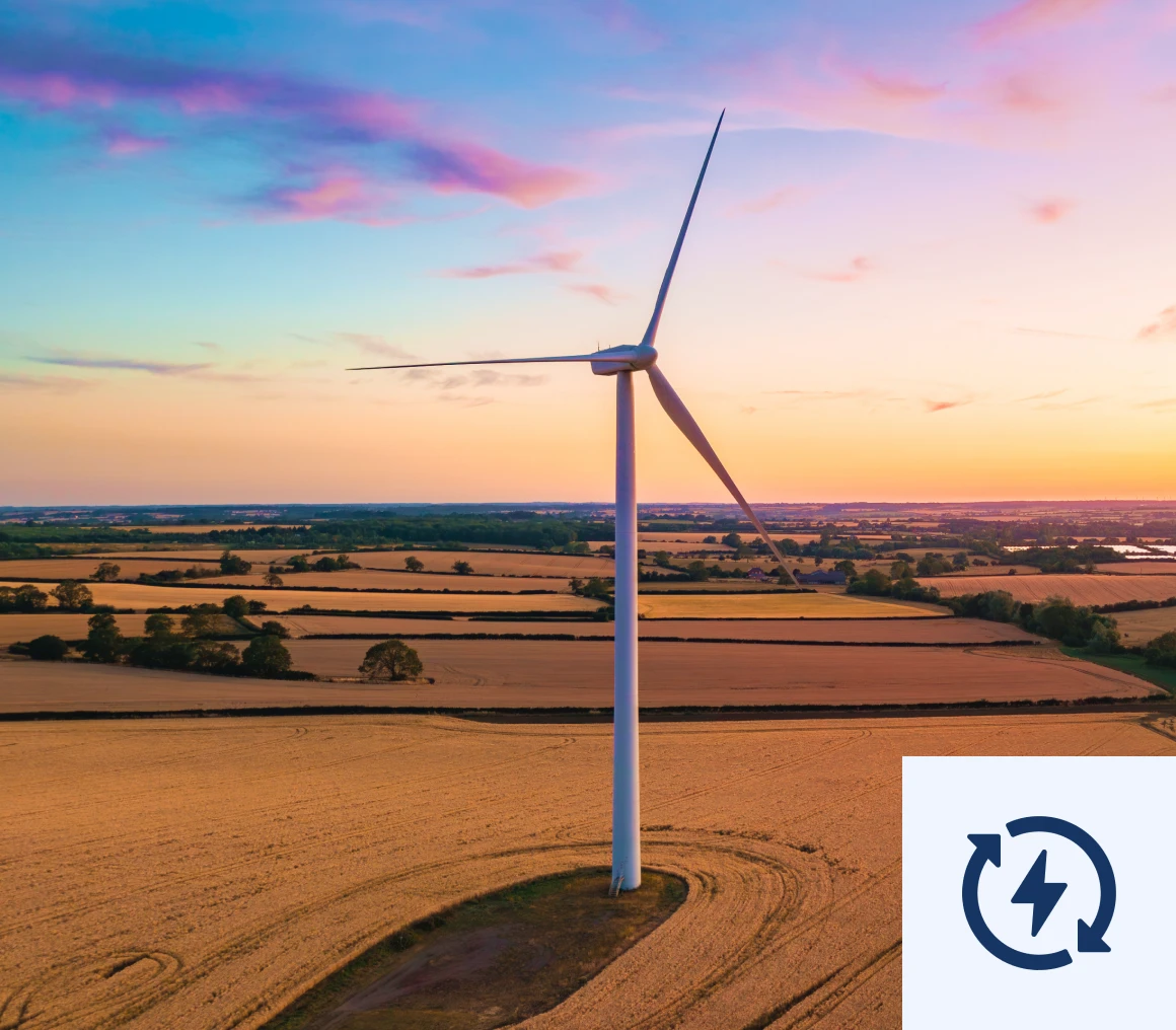 Wind turbine in a field at golden hour
